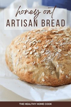 a loaf of artisan bread sitting on top of a piece of wax paper with the words, honey out artisan bread