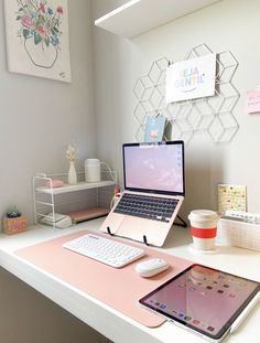 a laptop computer sitting on top of a white desk