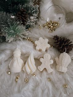 christmas decorations are laying on a fur surface