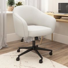 a white office chair sitting on top of a wooden floor next to a computer desk