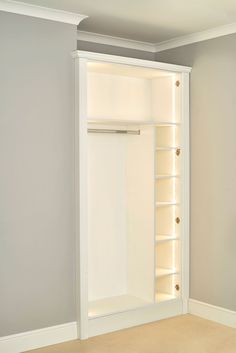 an empty closet with shelves and lights on the wall in a room that is painted white