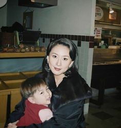 a woman holding a small child in her arms