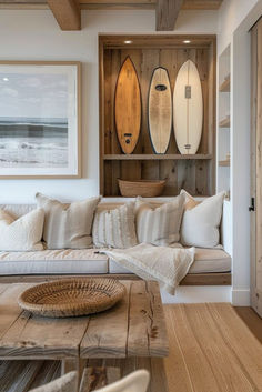 a living room filled with lots of furniture and surfboards on the wall above it