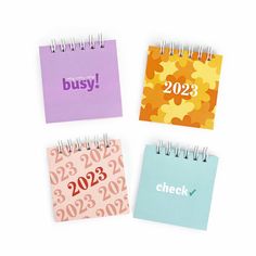 three calendars with the words busy, check, and 203 printed on them in different colors