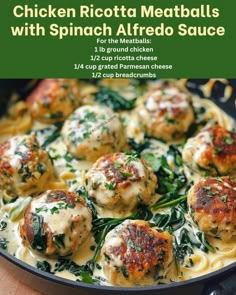 chicken ricotta meatballs with spinach alfredo sauce in a cast iron skillet