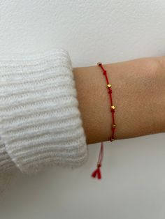 This delicate little red string bracelet is made with natural silk.  The focal point is made of 7 beads. The number seven is considered to be lucky and is the most significant number of the Bible as it is the number of spiritual perfection. It is believed that when you no longer need its protection it will fall off. D E T A I L S *Tiny  Karen Hill tribe nuggets  measuring around 2mm have been hand strung onto a natural silk cord  *These are handmade in Thailand using traditional silversmith tech Red Friendship Bracelets With Gold Beads As Gift, Red Friendship Bracelet With Gold Beads As Gift, Minimalist Red Friendship Bracelet With Sliding Knot, Everyday Red Friendship Bracelet With Round Beads, Dainty Red Beaded Bracelets For Everyday, Dainty Red Bracelet With Sliding Knot, Minimalist Red Beaded Bracelet With Tiny Beads, Red Minimalist Beaded Bracelets For Friendship, Minimalist Red Beaded Bracelets For Friendship