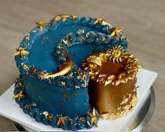 a blue cake with gold stars on it