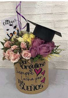 a graduation hat with flowers in it and a sign that says congratulations to someone who is graduating