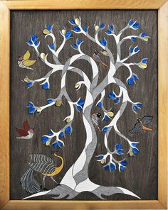 a tree with blue leaves and birds painted on the branches is in a wooden frame