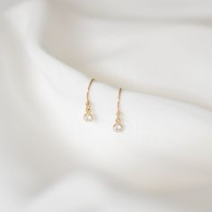 Simple and perfect for everyday wear, these dainty earrings feature a 3mm brilliant dangling cubic zirconia charm. These are all made of 14K gold filled materials and are tarnish-resistant, water-resistant, and hypoallergenic.  Comes with box and jewelry pouch, ready for gifting. --------------------♥ PROMOS ♥-------------------- Want 10% off? Join the mailing list by visiting http://bit.ly/vedern . Just leave me a note at checkout if you have any problems applying discount codes. --------------------♥ BUY WITH CONFIDENCE ♥-------------------- Don't love it? Message me to set up a return or exchange. If you find any problems with your items, just send a message with a photo, and a new one will be on its way to you! --------------------------♥ PACKAGING ♥--------------------------- Gold fil Minimalist Diamond Drop Earrings, Dainty Diamond Earrings For Anniversary, Minimalist Hypoallergenic Diamond Drop Earrings, Dainty Rose Gold Diamond Earrings, Minimalist Dangle Diamond Earrings, Dainty 14k Yellow Gold-filled Earrings, Dainty 14k Yellow Gold Filled Earrings, Dainty Everyday Diamond Earrings, Minimalist Hypoallergenic Diamond Earrings Gift