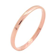 a rose gold wedding ring on a white background