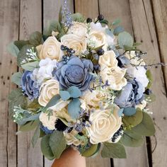 a bridal bouquet with blue and white flowers