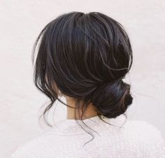 the back of a woman's head wearing a white sweater