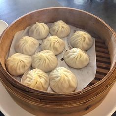 some dumplings are sitting in a wooden container