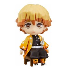 an anime figurine sitting on top of a wooden chair with orange hair and black pants