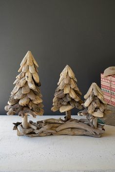 three small wooden trees sitting on top of a table