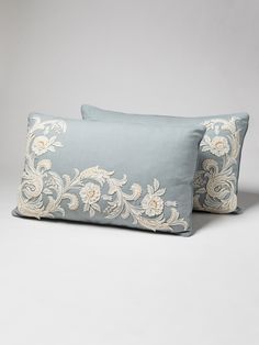 two blue pillows sitting on top of each other