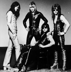 the group of young men are posing for a black and white photo with their guitars