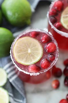 two glasses filled with cranberry lemonade and garnish