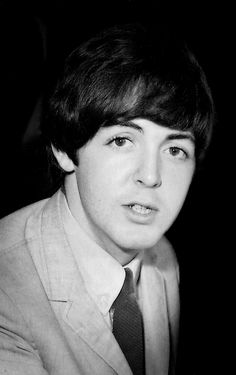 an old black and white photo of a young man wearing a suit with a tie