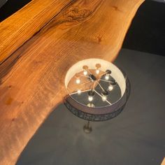 a wooden table topped with a clock on top of it