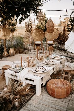 an outdoor table set up with plates and place settings