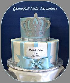 a blue and white cake with a tiara on top that says graceful cake creations