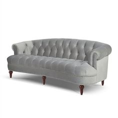 a gray couch with wooden legs and buttons on it's back end, sitting in front of a white background