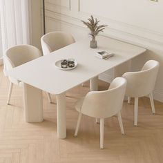 a white table with four chairs around it