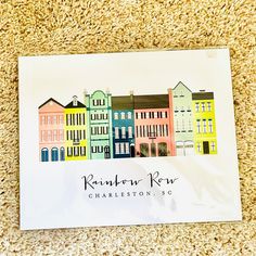 a paper with the name rainbow row charleston, sc on it sitting on a carpet