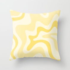 a yellow and white pillow sitting on top of a wall