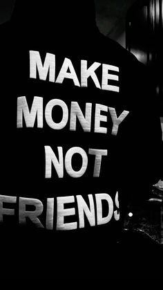 black and white photograph of a man with the words make money not friends written on his back