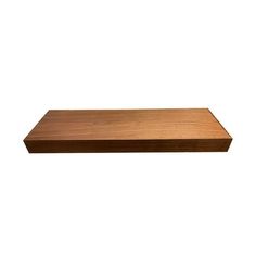 a wooden shelf that is on top of a white wall and has no one in it