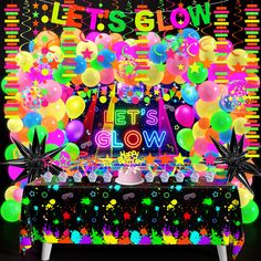 this is an image of a party with neon lights and balloons on the table in front of it