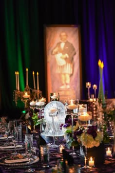 the table is set with candles and plates