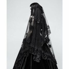 a black veil with lace and flowers on the bottom is hanging in front of a white background