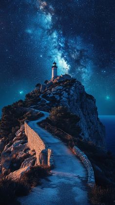 Majestic lighthouse on mountain with curved road to the top - clear night with starry sky.  #lighthouse #mountains #road #night #sky #starry Beautiful Night Sky, Dreamy Artwork, Wuthering Heights, Starry Sky, Scenery Wallpaper, Nature Travel, Night Sky, Night Skies