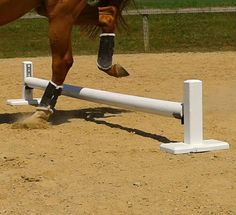 a horse that is jumping over an obstacle