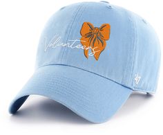 a light blue hat with an orange bow on the front and words written in white