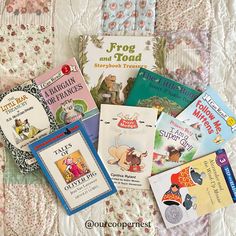 there are many children's books on the bed together, including one for frog and toad