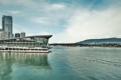 a large boat floating on top of a body of water near tall buildings in the background