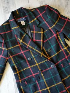 Snazzy retro jacket Plaid / windowpane tweed blazer Size 4 Petite Preppy and versatile Jacket is in very nice vintage condition Great assets such as: Medium size shoulder pads (just enough to define, not huge) 2 front pockets Fully lined Extra sleeve seam for better style and comfort One button closure Black with red, green and yellow  Clean * Sharp * Classic Please study photos for added description and measurements Thank you for visiting MidWestMerc! Retro Formal Tweed Blazer, Retro Tweed Blazer With Notch Lapel, Tailored Vintage Tweed Blazer, Tailored Retro Tweed Blazer, Retro Tailored Tweed Blazer, Vintage Wool Sport Coat For Office, Vintage Tweed Single-breasted Blazer, Vintage Notch Lapel Tweed Jacket For Office, Vintage Tweed Jacket With Notch Lapel For Office