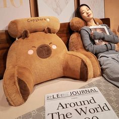 a woman laying in bed next to a giant teddy bear