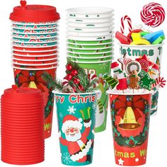 christmas themed cups and plates are stacked on top of each other