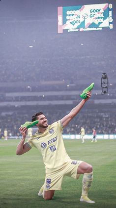 a soccer player is holding his leg up in the air and stretching to catch a ball