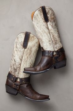 With their unique rugged beauty, no-holds-barred western style, and rich combination of textures, the Florence leather boots are an unforgettable addition to your wardrobe. These handcrafted kicks feature goatskin leather uppers and hair-on cowhide shafts, with goatskin pullstraps for easy wear. Strappy harness detailing with studs adorns each side of the boot, while leather heels and outsoles offer a durable step. With calfskin leather lining, cushioned footbeds, and welt construction. Cowhide Boots, Tall Western Boots, Tall Western Boot, 2024 Wardrobe, Cowboy Boots For Women, Girl Boots, Stylish Footwear, Handmade Boot, Leather Cowboy Boots