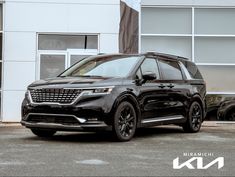 a black suv parked in front of a building