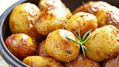 cooked potatoes in a pot with rosemary garnish on the top, ready to be eaten