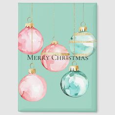 a christmas card with pink and blue ornaments hanging from it's sides on a green background