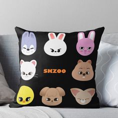 a pillow that has various faces on it and the words skoo written in different languages